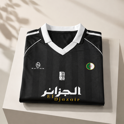Black piped Djazaïr jersey folded flat, white V-neck and الجزائر lettering